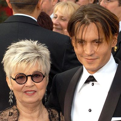 Debbie Depp is wearing a black specs while Johnny is on tuxedo.